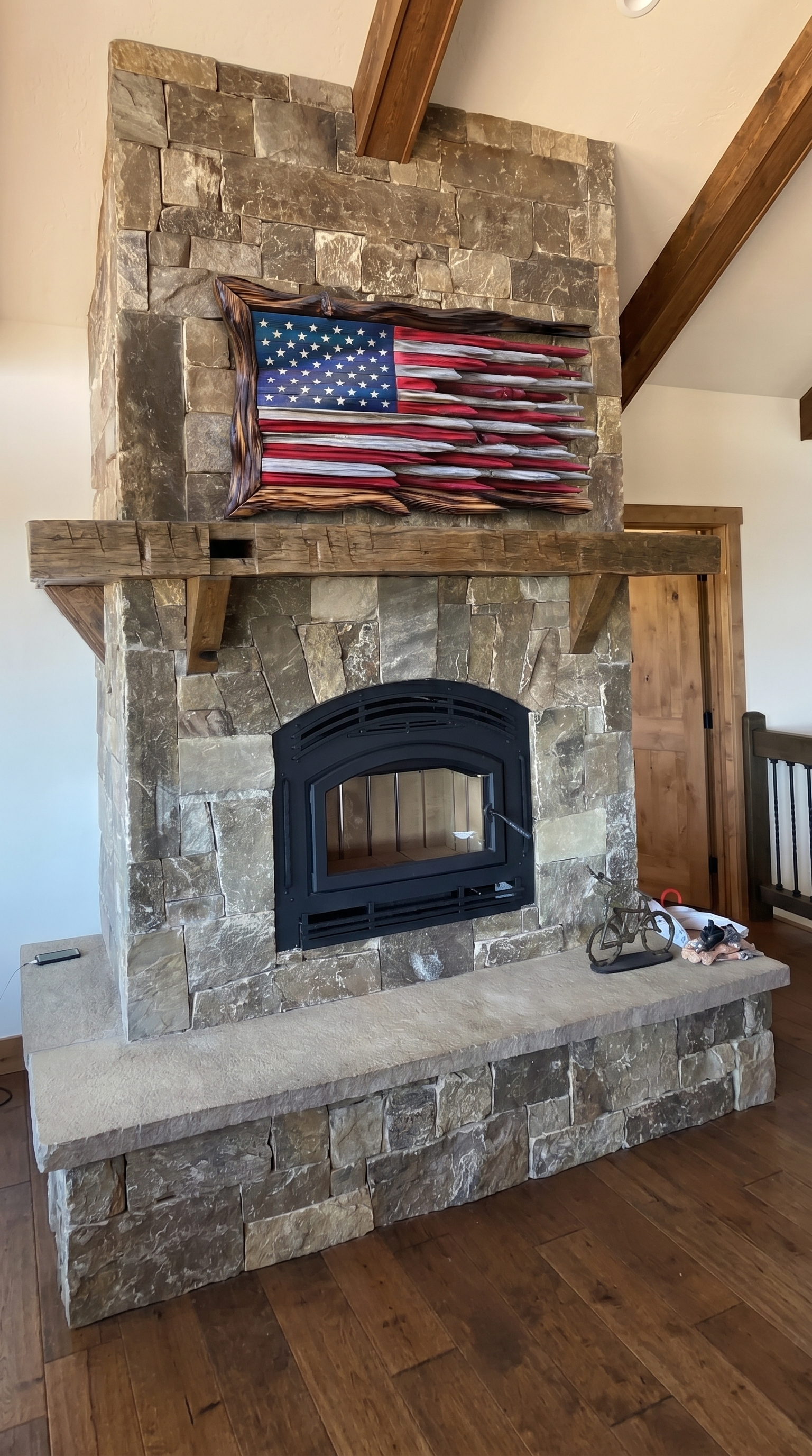 Wood flag displayed over a stone fireplace